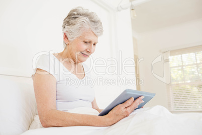 Smiling woman using tablet Smiling woman using tablet