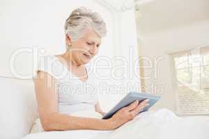 Smiling woman using tablet