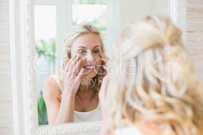 Beautiful woman looking at herself in the mirror