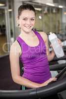 Smiling woman holding bottle of water