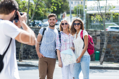 Hip man taking picture of his friends