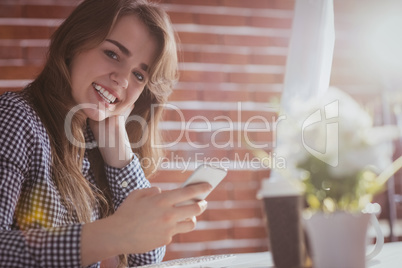 Young hipster businesswoman using her phone
