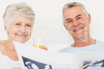 Senior couple reading newspaper