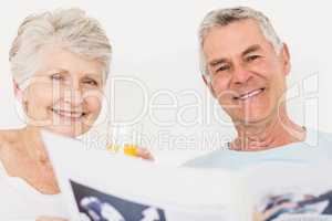 Senior couple reading newspaper