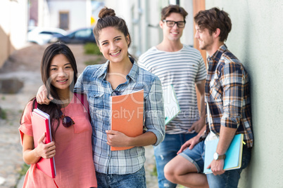 Hip friends holding notebooks