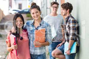 Hip friends holding notebooks