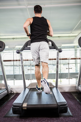 Fit man running on treadmill