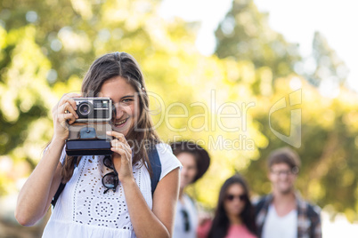 Hip woman taking picture of the camera