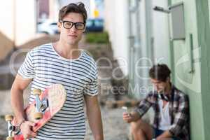 Hip man holding skateboard