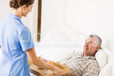 Nurse taking care of suffering senior patient