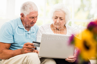 Focused senior couple using laptop Focused senior couple using laptop