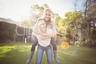 Husband giving piggy back to wife