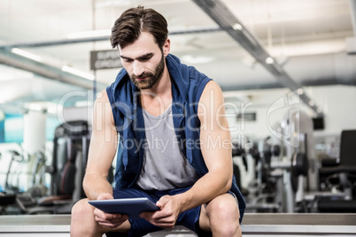 Thoughtful man using tablet