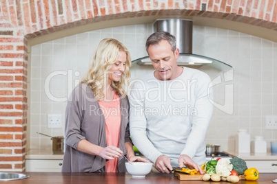 Cute couple slicing vegetables