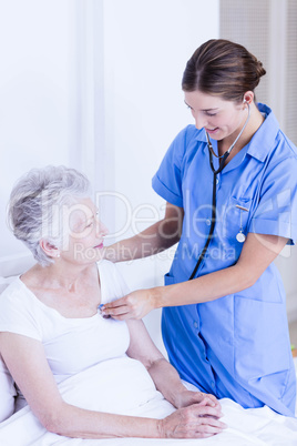 Doctor taking care of suffering senior patient