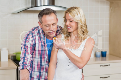 Woman giving something to eat at her husband