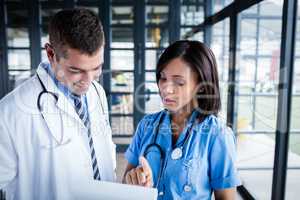 Nurse and doctor looking at files