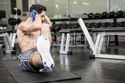 Shirtless man doing sitting up