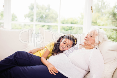 Relaxed granddaughter and grandmother napping