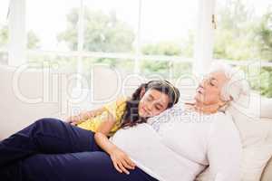 Relaxed granddaughter and grandmother napping