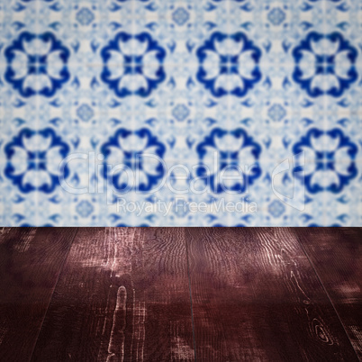 Wood table top and blur vintage ceramic tile pattern wall