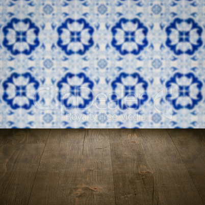 Wood table top and blur vintage ceramic tile pattern wall