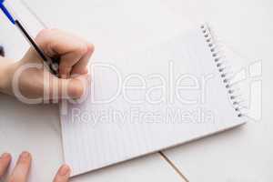 Businesswoman writing on notebook