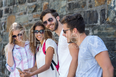 Hip friends looking at smartphone