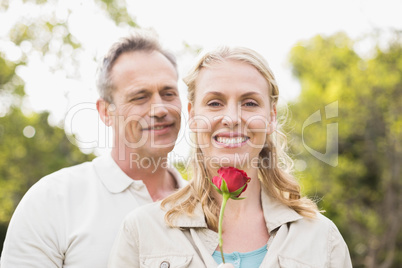 Cute couple holding a rose