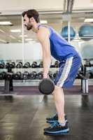 Muscular man lifting barbell