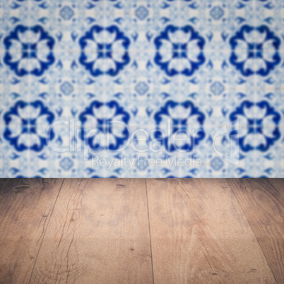 Wood table top and blur vintage ceramic tile pattern wall