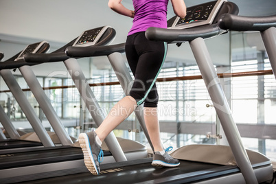 Lower section of fit woman on treadmill
