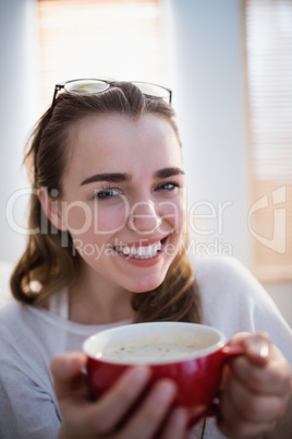 Pretty woman relaxing on couch with coffee