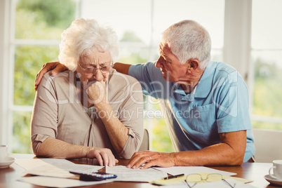 Senior couple counting bills