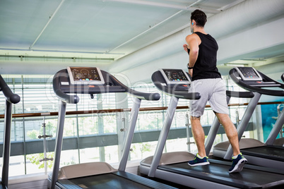 Fit man running on treadmill