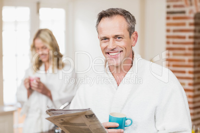 Cute couple having coffee and reading news