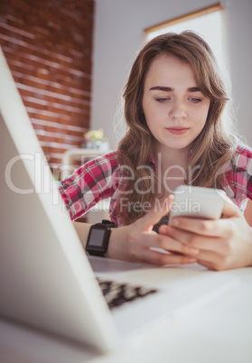 Young hipster businesswoman using her phone