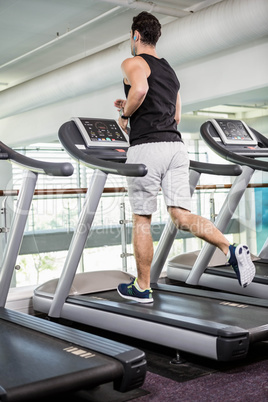 Fit man running on treadmill