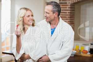 Cute couple cuddling in bathrobes