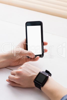 Casual businessman using phone and smart watch