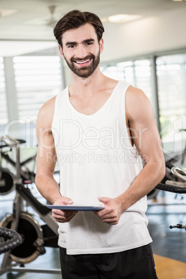 Smiling man holding tablet