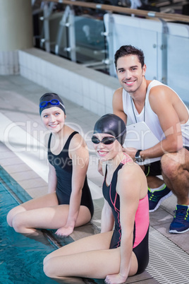 Trainer and swimmers smiling at the camera