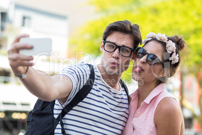 Hip couple taking selfie