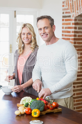 Cute couple slicing vegetables