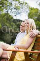 Happy couple sitting on a bench