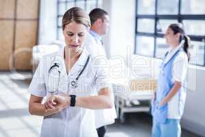 Nurse checking her smart watch