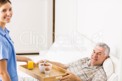 Nurse taking care of suffering senior patient