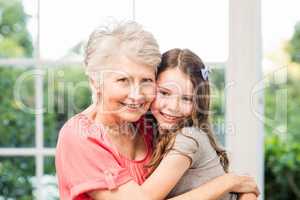 Grandmother and granddaughter embracing