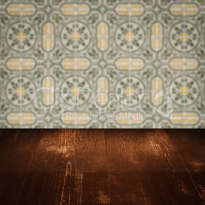 Wood table top and blur vintage ceramic tile pattern wall Wood table top and blur vintage ceramic tile pattern wall