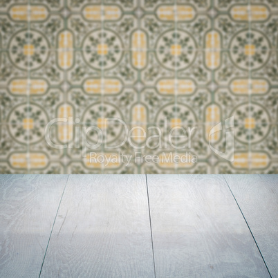 Wood table top and blur vintage ceramic tile pattern wall